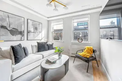 a living room with a couch and a table at 3BR Penthouse Suite with Massive Private Rooftop in New York