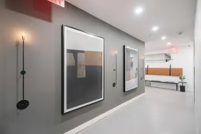 a hallway with two framed pictures on a wall at 3BR Penthouse Suite with Massive Private Rooftop in New York