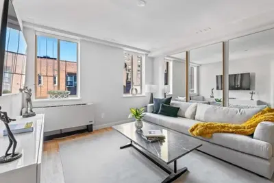 a living room with a couch and a table at 3BR Penthouse with Massive Private Rooftop in New York