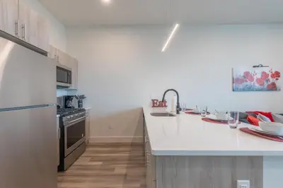 a kitchen with a white counter top and a refrigerator at Stylish Apt FREE Parking Near NYC & Airport in East Orange