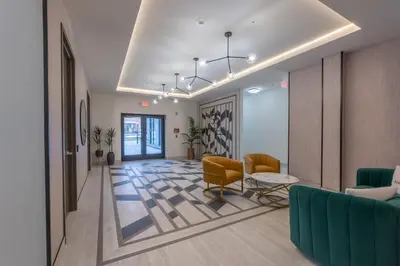 an office lobby with chairs and a couch and a table at Stylish Apt FREE Parking Near NYC & Airport in East Orange