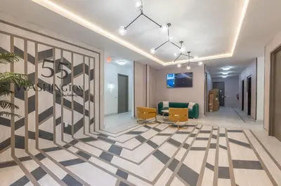 a lobby with a dancing company sign on the wall at Stylish Apt FREE Parking Near NYC & Airport in East Orange
