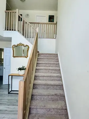 a staircase in a house with a mirror on the wall at Warmth Private Room in Stillwater Lake Estates