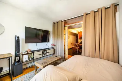 a bedroom with a bed and a flat screen tv at BEST LOCATION IN QUEENS, Everything is near by, PRIVATE ROOM, LaGuardia Airport 10min in Queens