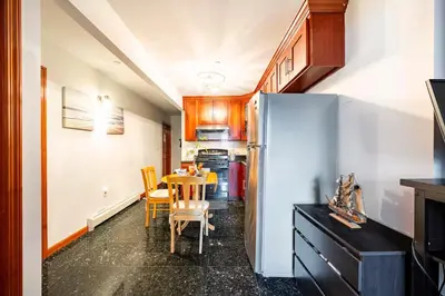 a kitchen with a table and a refrigerator at BEST LOCATION IN QUEENS, Everything is near by, PRIVATE ROOM, LaGuardia Airport 10min in Queens