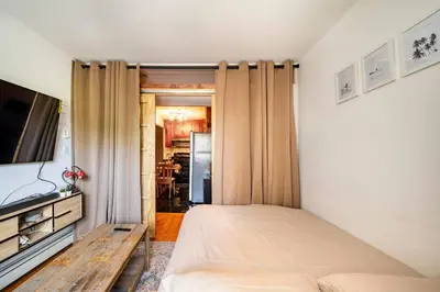 a bedroom with a bed and a flat screen tv at BEST LOCATION IN QUEENS, Everything is near by, PRIVATE ROOM, LaGuardia Airport 10min in Queens