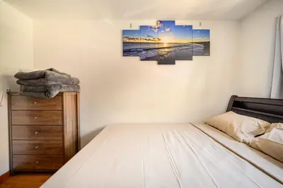 a bedroom with a bed and a painting on the wall at BEST Large Private Room & Private Bathroom, LaGuardia Airport 10min in Queens