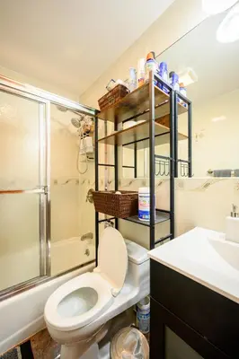 a bathroom with a toilet and a sink and a shower at BEST Large Private Room & Private Bathroom, LaGuardia Airport 10min in Queens