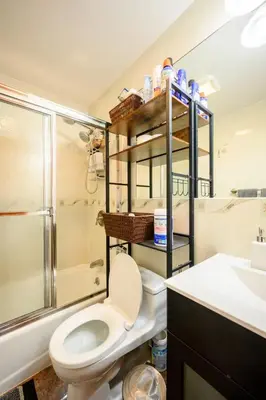a bathroom with a toilet and a shower and a sink at BEST Large Private Room & Private Bathroom, LaGuardia Airport 10min in Queens