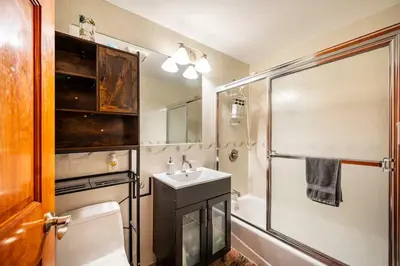a bathroom with a toilet and a sink and a shower at BEST Large Private Room & Private Bathroom, LaGuardia Airport 10min in Queens