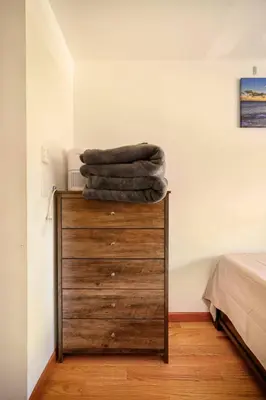 a pile of towels sitting on top of a dresser at BEST Large Private Room & Private Bathroom, LaGuardia Airport 10min in Queens