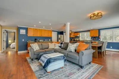 a living room with a couch and a table at Ski, Golf and Hike Spacious Dover Retreat! in Dover
