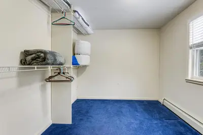 a room with a blue carpeted floor and white walls at Ski, Golf and Hike Spacious Dover Retreat! in Dover