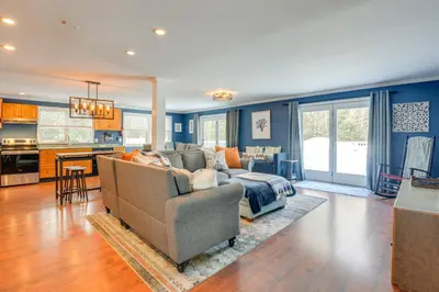 a living room with a couch and a kitchen at Ski, Golf and Hike Spacious Dover Retreat! in Dover
