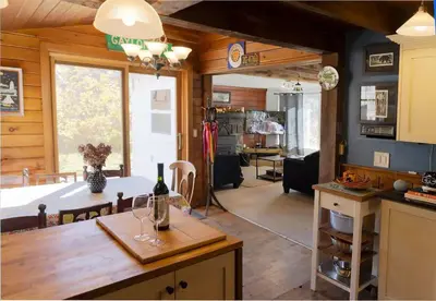 a kitchen and living room with a table and a dining room at 1894 Catskills Farmhouse Retreat in Tannersville