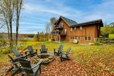 a group of chairs sitting in front of a house at Golf, Fish and Ski Retreat with Game Room in Thompson in Thompson