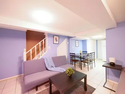 a living room with a couch and a table at Cozy Studio Unit Close to New York City in Jersey City