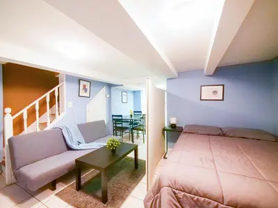 a bedroom with a bed and a couch and a table at Cozy Studio Unit Close to New York City in Jersey City