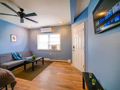 a living room with a couch and a ceiling fan at New Studio unit near the heart of NYC in Jersey City