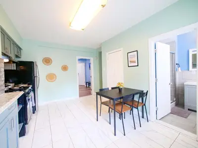 a kitchen with a black table and chairs at New Studio unit near the heart of NYC in Jersey City