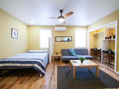 a bedroom with a bed and a couch and a table at 2BED Cozy unit near NYC attractions in Jersey City