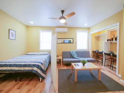 a bedroom with a bed and a couch and a table at 2BED Cozy unit near NYC attractions in Jersey City