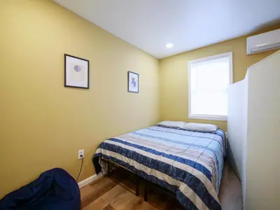 a small bedroom with a bed and a window at 2BED Cozy unit near NYC attractions in Jersey City
