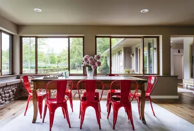 a dining room with a table and red chairs at Antrim Streamside in Livingston Manor