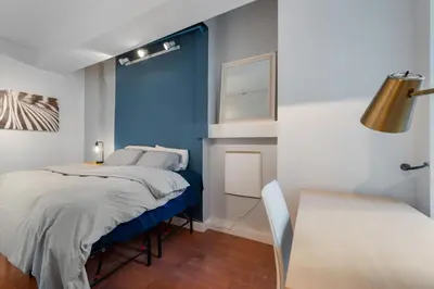 a bedroom with a bed with a blue wall at 4 Bedroom 1 Bathroom Hudson Yard in New York