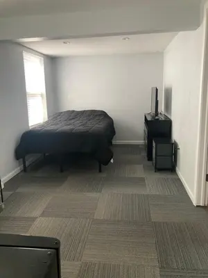 a bedroom with a bed and a television in it at Cozy bedroom with en-suite bathroom in Naugatuck