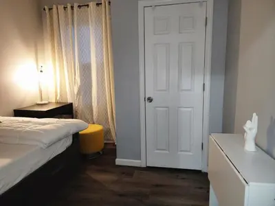 a bedroom with a bed and a white door at Comfy Fairmount in Newark