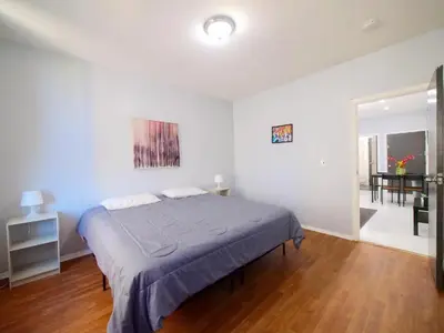 a bedroom with a bed and a dining room at Sleek one-bedroom abode near NYC in Jersey City