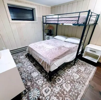 a bedroom with a bunk bed and a rug at 6BD 3BA - Mount Snow VT - Ski-Back Trail - Shuttle in Dover