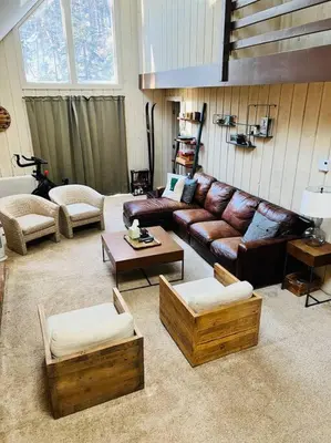 a living room with a leather couch and tables at 6BD 3BA - Mount Snow VT - Ski-Back Trail - Shuttle in Dover