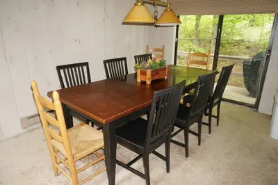 a dining room table with black chairs and a wooden table at 6BD 3BA - Mount Snow VT - Ski-Back Trail - Shuttle in Dover