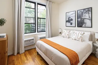 a bedroom with a large bed and a window at Cozy Apartment in the Upper East Side in New York