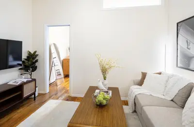 a living room with a couch and a table at Cozy Apartment in the Upper East Side in New York