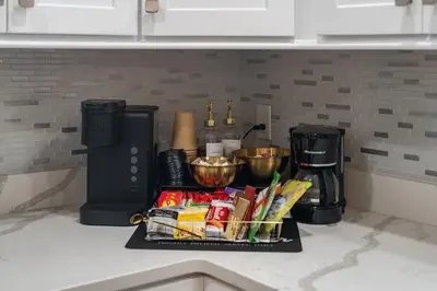 a tray of food on a kitchen counter with a coffee maker at Upscale 4BR Retreat at the Reservoir! in Bridgeport