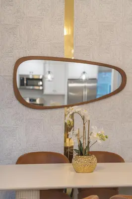 a table with a mirror and a vase with flowers at Upscale 4BR Retreat at the Reservoir! in Bridgeport