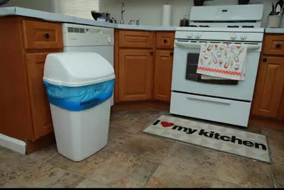 a kitchen with a trash can next to a stove at Elegant 3BR Home - Near the Prudential Center in Newark