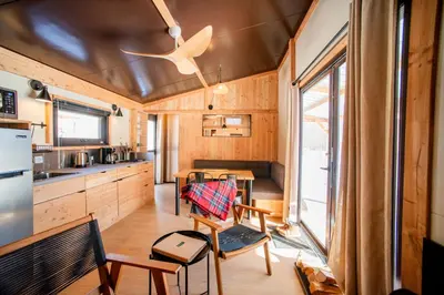 a kitchen and dining room of a tiny house at Huttopia Berkshires in Hancock