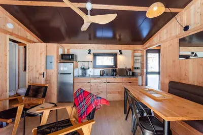 a kitchen and dining room of a tiny house at Huttopia Berkshires in Hancock