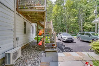 a ladder on the side of a house with a car at 3 Mi to Hiking Cozy Mt Tremper Apt in Mount Pleasant