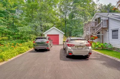 two cars parked in the driveway of a house at 3 Mi to Hiking Cozy Mt Tremper Apt in Mount Pleasant