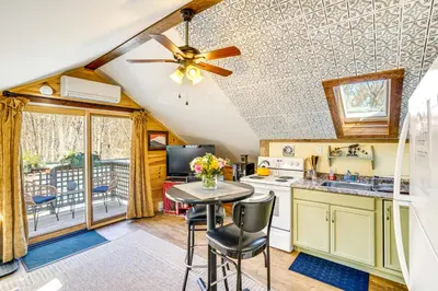 a kitchen with a ceiling fan and a table with chairs at 3 Mi to Hiking Cozy Mt Tremper Apt in Mount Pleasant