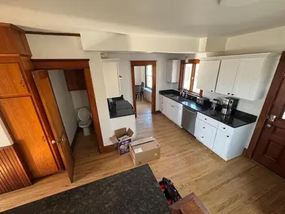an aerial view of a kitchen with white cabinets at Warm and Cozy 4Bd 2Bath in Southington