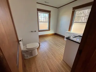 an empty bathroom with a toilet and a sink at Warm and Cozy 4Bd 2Bath in Southington