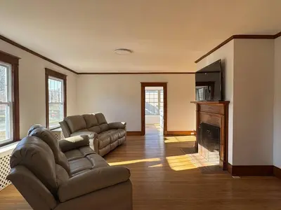 a living room with a couch and a fireplace at Warm and Cozy 4Bd 2Bath in Southington