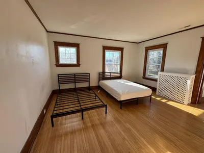 a room with a bed and a bed frame in it at Warm and Cozy 4Bd 2Bath in Southington