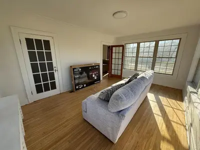 a living room with a couch and a tv at Warm and Cozy 4Bd 2Bath in Southington